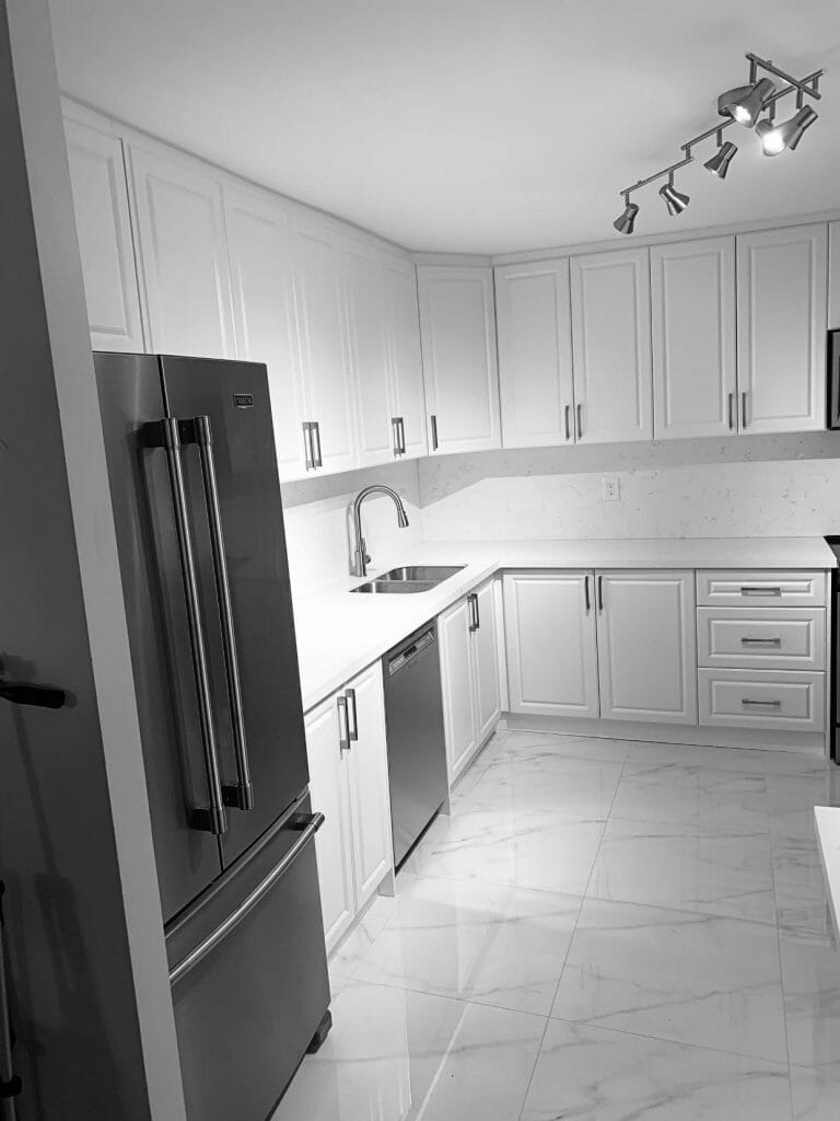 Showcasing a large kitchen with a dishwasher, a double-door refrigerator, and kitchen cabinets with loads of storage space. by Desa Contracting, Restoration, and Janitorial Services, Toronto.