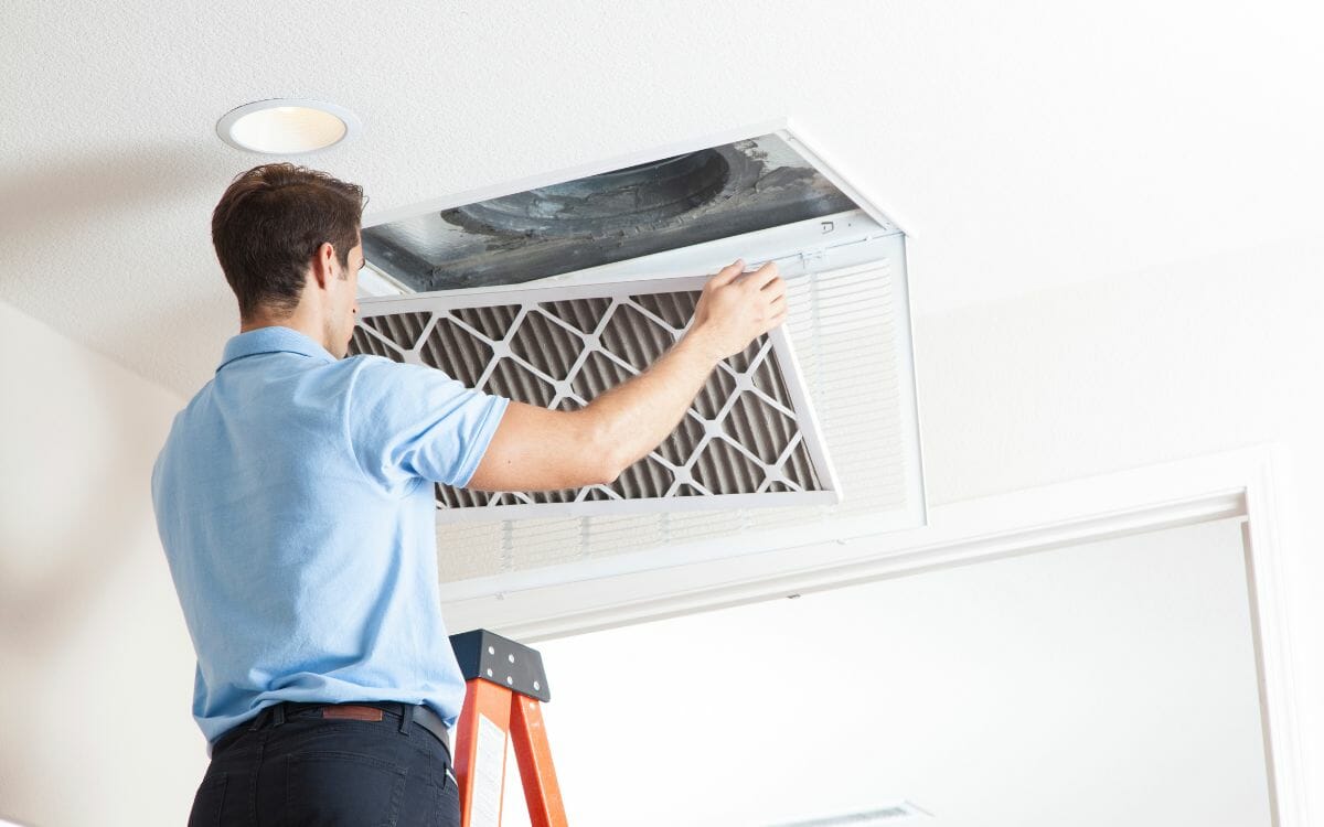 This image captures a Desa Contracting and Restoration specialist repairing a ceiling floor vent in Toronto.