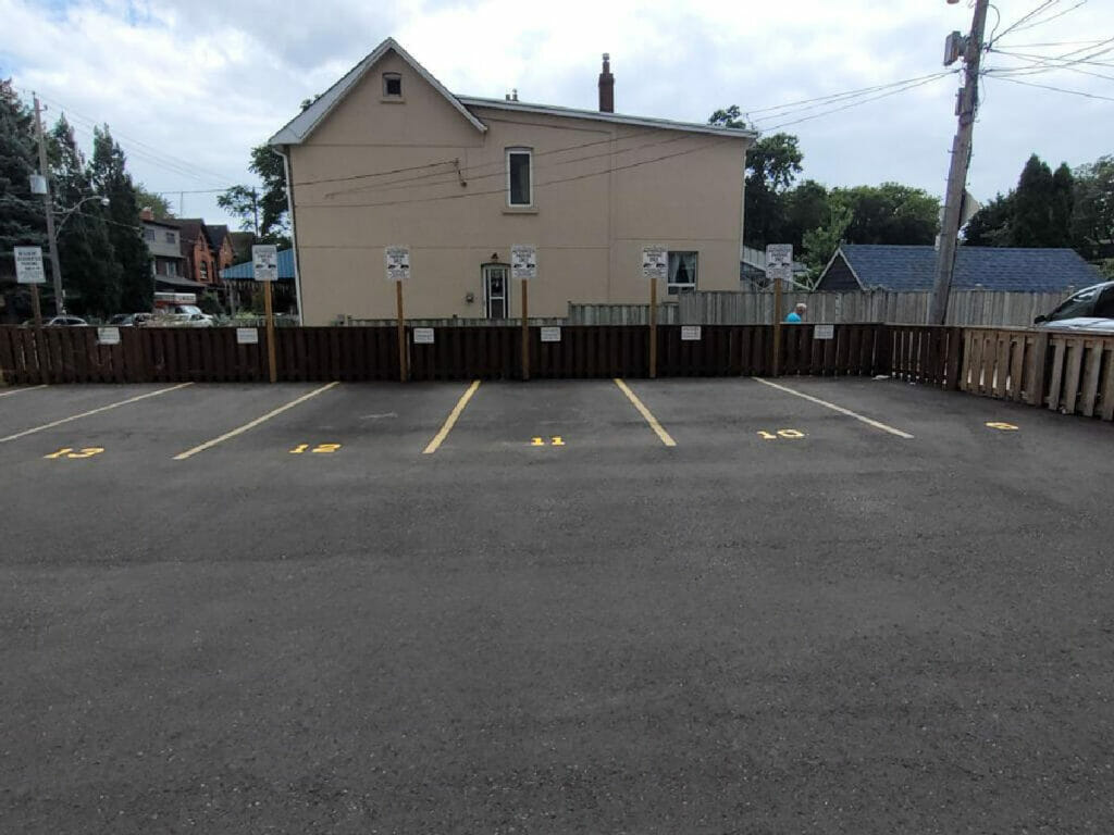 This image shows a painting created by Desa Contracting, Restoration, and Janitorial Services of the five parking spaces at a Toronto open area.