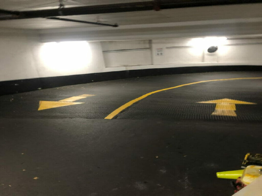 At a condo in Toronto, Desa Contracting, Restoration, and Janitorial Services just painted direction arrows that serve as signs for cars to go to and from their respective parking spaces.