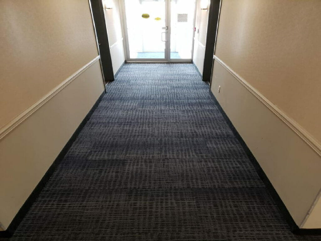 Desa Contracting Restoration and Janitorial Service expertly rebuilt a condo's entrance, which has a glass front door.